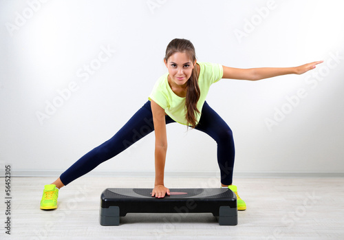 Photo: Beautiful young girl doing exercises at home Beautiful young girl doing exercises at home