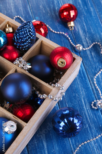 Photo: Christmas toys in box on wooden table close-up Christmas toys in box on wooden table close-up