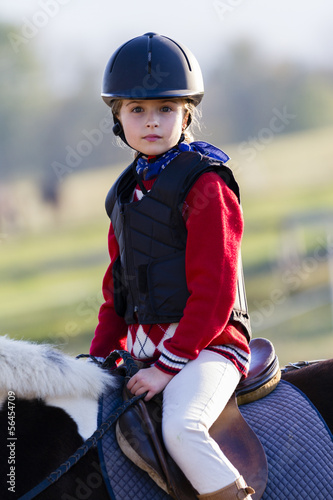 Photo: Horse riding, portrait of lovely equestrian on a horse Horse riding, portrait of lovely equestrian on a horse