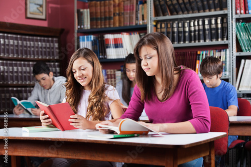Photo: Teenage Students Studying In Library Teenage Students Studying In Library