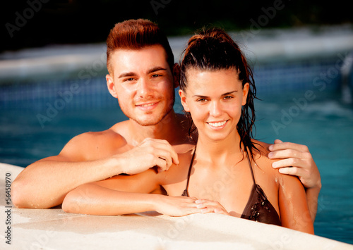 Photo: Happy couple relaxing in the pool Happy couple relaxing in the pool