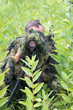 Photographer in ghillie suit in action Photographer in ghillie suit in action