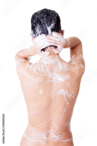 Photo: Young woman in shower washing her body Young woman in shower washing her body