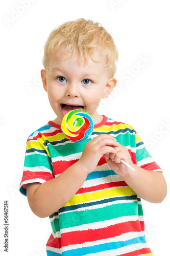 Photo: kid boy eating lollipop isolated kid boy eating lollipop isolated