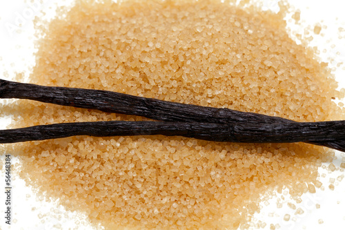 Photo: vanilla beans and brown vanilla sugar isolated on white backgrou vanilla beans and brown vanilla sugar isolated on white backgrou