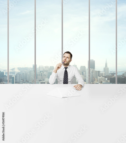 Photo: businessman sitting in office businessman sitting in office