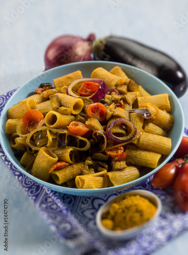 Photo: pasta with eggplants tomatoes and curry, selective focus pasta with eggplants tomatoes and curry, selective focus