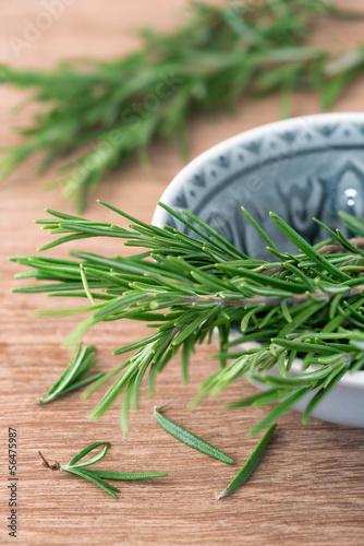 Photo: Bunch of rosemary on a rustic wood Bunch of rosemary on a rustic wood