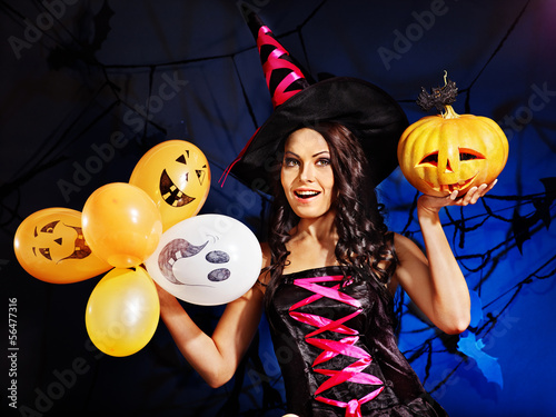 Photo: Happy woman holding pumpkin and balloon. Happy woman holding pumpkin and balloon.