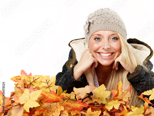 Photo: Woman has fun with leaves in autumn Woman has fun with leaves in autumn