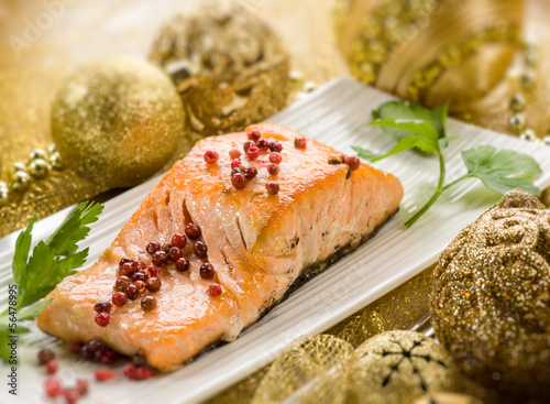 Photo: grilled salmon with pink pepper on christmas table grilled salmon with pink pepper on christmas table