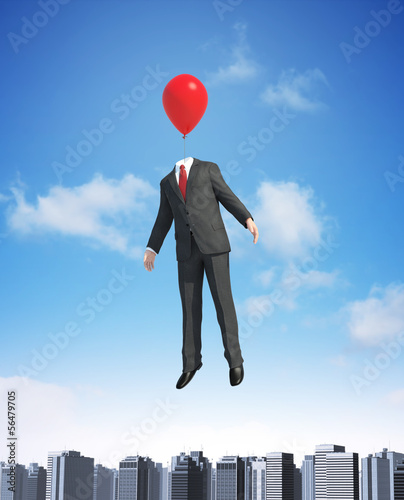 Photo: Balloon man floating above a city Balloon man floating above a city