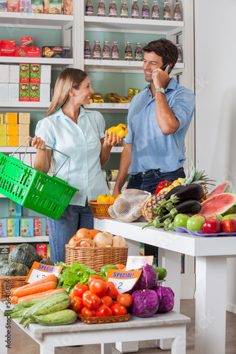 Photo: Couple Shopping Vegetables In Supermarket Couple Shopping Vegetables In Supermarket