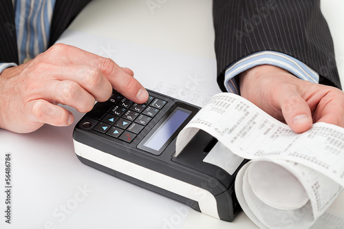 Photo: Hands with cash register Hands with cash register