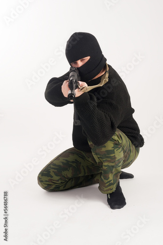Photo: masked man aims with rifle masked man aims with rifle