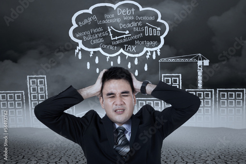 Photo: Stressed businessman with a headache Stressed businessman with a headache