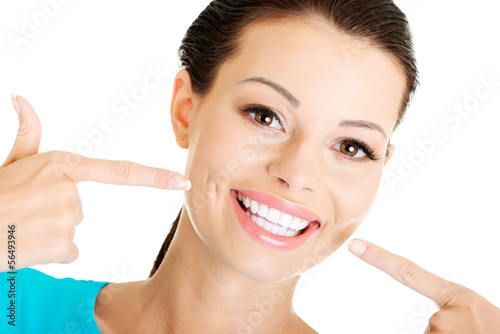 Photo: Woman showing her perfect teeth. Woman showing her perfect teeth.