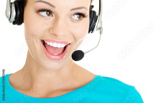 Photo: Beautiful young call-center assistant smiling Beautiful young call-center assistant smiling