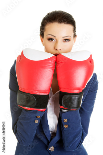 Photo: Young businesswoman with boxing gloves Young businesswoman with boxing gloves