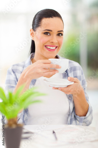 Photo: young adult woman drinking coffee young adult woman drinking coffee