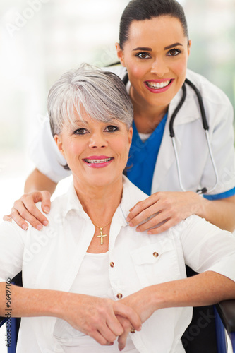 Photo: senior woman in wheelchair with caregiver senior woman in wheelchair with caregiver