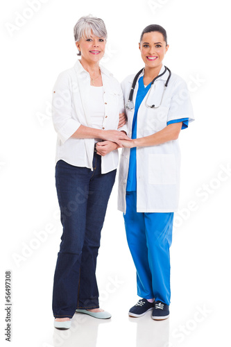 Photo: medical doctor standing with senior patient medical doctor standing with senior patient