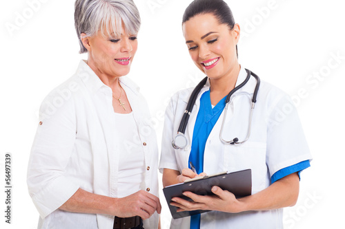 Photo: doctor helping senior woman with medical form doctor helping senior woman with medical form