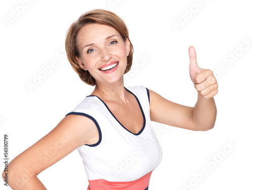 Photo: Portrait of a beautiful adult happy woman with thumbs up sign Portrait of a beautiful adult happy woman with thumbs up sign