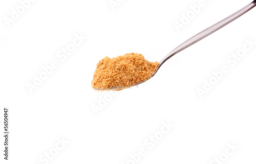 Photo: a spoon of brown sugar isolated on white a spoon of brown sugar isolated on white