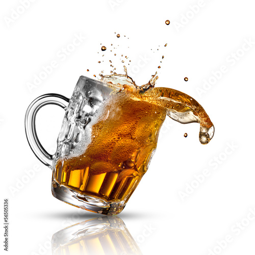 Photo: Beer splash in glass isolated on white Beer splash in glass isolated on white