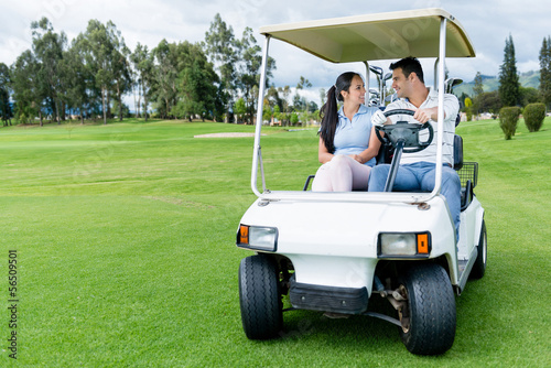 Photo: Couple in a golf cart Couple in a golf cart