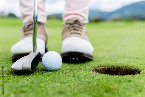 Photo: Golf player at the green Golf player at the green