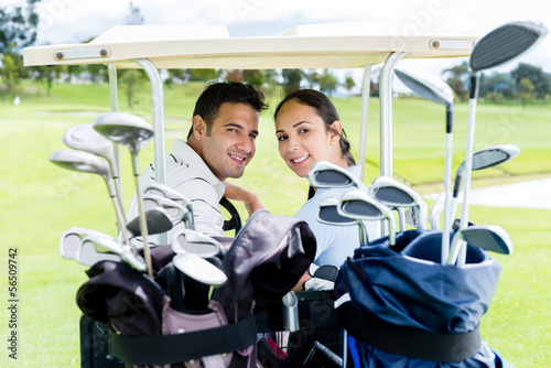 Photo: Couple in a golf cart Couple in a golf cart