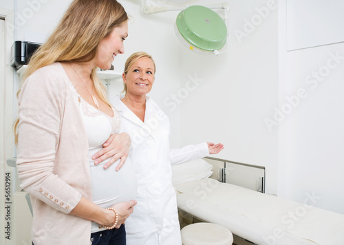 Photo: Gynecologist Gesturing To Pregnant Woman Gynecologist Gesturing To Pregnant Woman