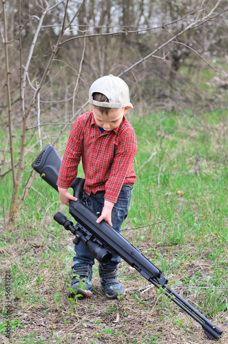 Photo: Small boy lugging a sporting rifle Small boy lugging a sporting rifle