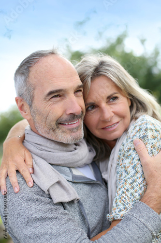 Photo: Cheerful senior couple enjoying peaceful nature Cheerful senior couple enjoying peaceful nature