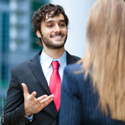Photo: Businesspeople talking outdoor Businesspeople talking outdoor