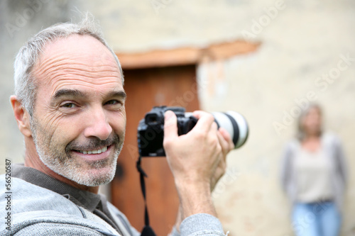 Photo: Senior photographer using digital camera Senior photographer using digital camera