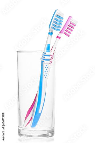 Photo: pair of new toothbrushes in a glass on a white background pair of new toothbrushes in a glass on a white background