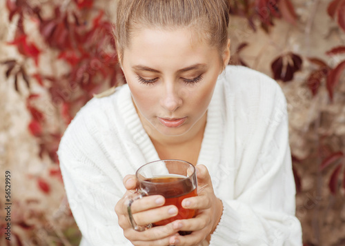Photo: Girl enjoying a large cup of freshly brewed hot tea Girl enjoying a large cup of freshly brewed hot tea