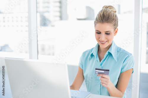 Photo: Smiling smart businesswoman shopping online Smiling smart businesswoman shopping online