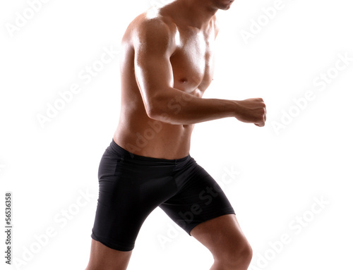 Photo: Saludable hombre deportista corriendo en fondo blanco. Saludable hombre deportista corriendo en fondo blanco.
