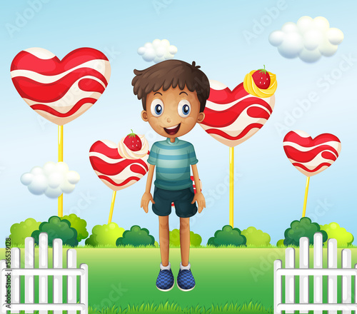 Vector: A smiling young boy standing in the garden with giant heart loll A smiling young boy standing in the garden with giant heart loll