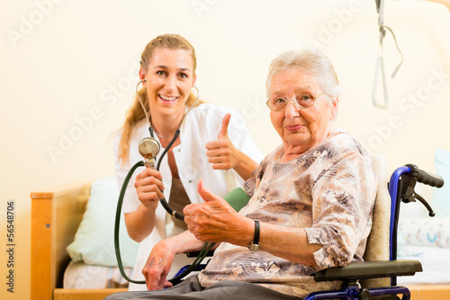 Photo: Young nurse and female senior in nursing home Young nurse and female senior in nursing home