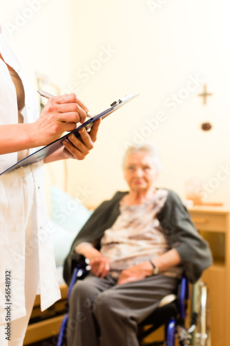 Photo: Young nurse and female senior in nursing home Young nurse and female senior in nursing home