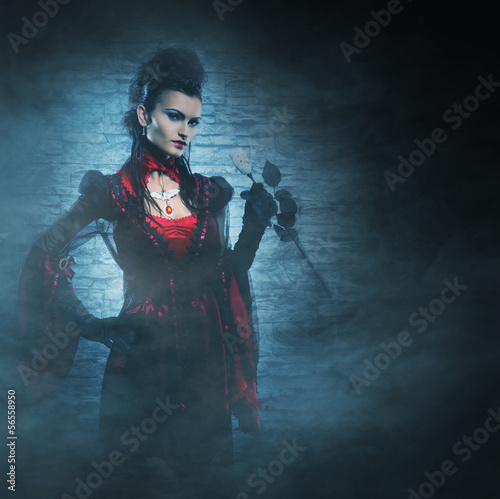 Photo: Halloween concept: a young and sexy lady vampire in the dungeon Halloween concept: a young and sexy lady vampire in the dungeon