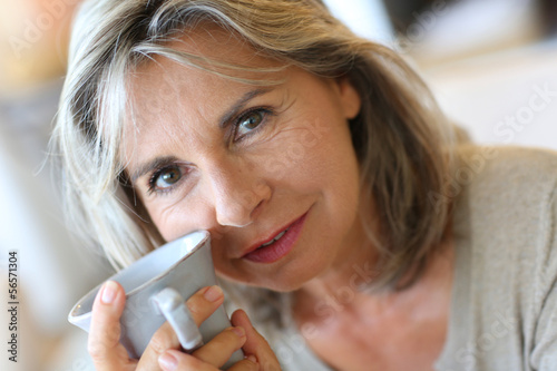 Photo: Portrait of senior woman holding cup of tea Portrait of senior woman holding cup of tea