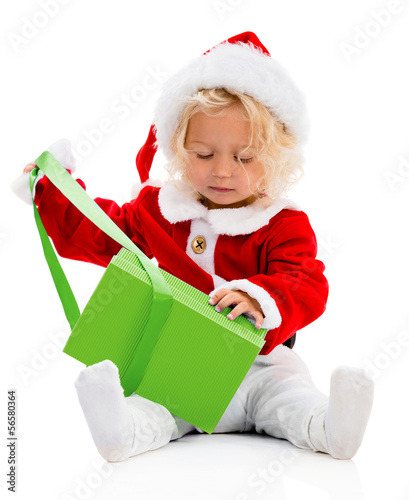 Photo: Girl opening a Christmas gift Girl opening a Christmas gift