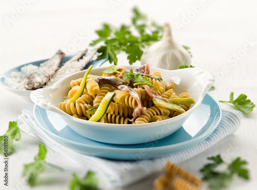 Photo: fusilli with anchovies and zucchinis, selective focus fusilli with anchovies and zucchinis, selective focus