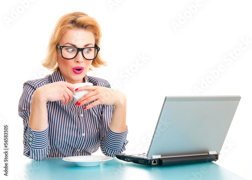 Photo: Funny surprised business woman watching in laptop Funny surprised business woman watching in laptop